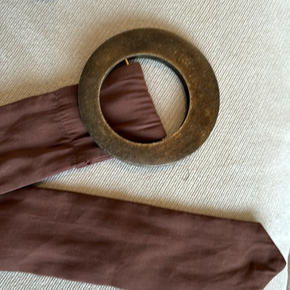 Cloth belt with large wooden buckle in browns